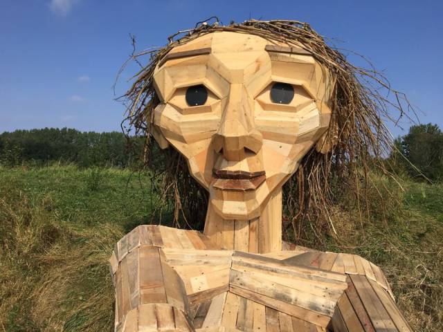 This Artist Creates Phenomenal Giant Sculptures From Recycled Wood In Completely Unexpected Places