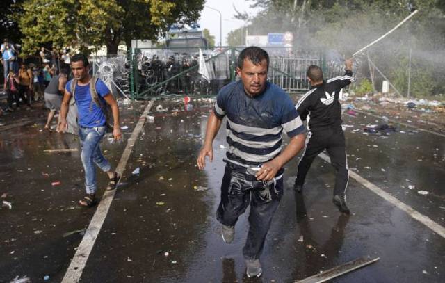 Hungarian Police Fight Migrants with Tear Gas and Water Cannons